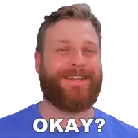 a man with a beard is wearing a blue shirt and says okay