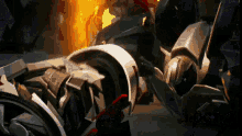 a robot is laying on the ground with a fire in the background .