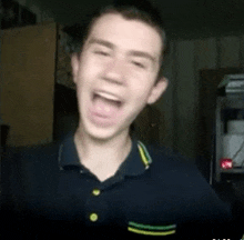 a young man in a black shirt is making a funny face with his mouth open