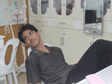 a man laying on his stomach in front of a skeleton and a 3m sign