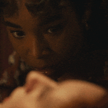 a close up of a woman 's face with a man 's ear visible