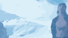 a man with a tattoo of a butterfly on his chest is standing in the snow