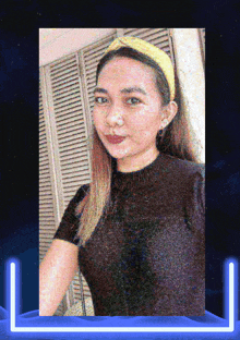 a woman wearing a yellow headband and a black shirt