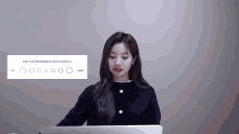 a woman is sitting in front of a laptop with circles on it