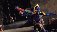 a person in a blue and orange costume is holding a sword