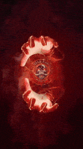 a picture of two hands holding a red object with a skull on it and the words blood family