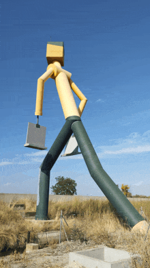 a statue of a man carrying a briefcase and a laptop