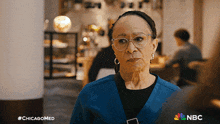 an older woman wearing glasses and a blue sweater is featured in a nbc ad
