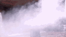 smoke is coming out of a pipe in a dark area