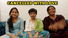 three women are sitting on a couch with the words cancelled with love above them