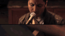 a man singing into a microphone next to a man singing into a microphone