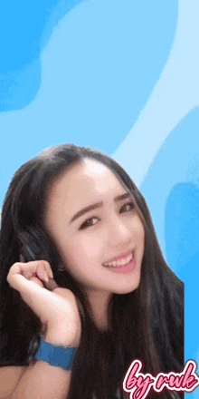 a woman wearing headphones and a blue watch with the words by rude written on the bottom
