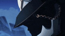 a silhouette of a person wearing a hat and chain around their neck