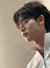 a close up of a young man 's face with his mouth open