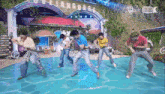a group of young men are dancing in front of a sign that says " language "