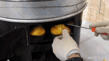 a person is taking a piece of food out of an oven that is made in animatica