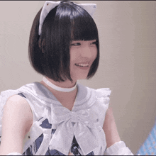 a woman wearing a cat ear headband and a white bow