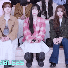 a group of young women are sitting in a row with the word able25 in the corner