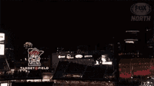a fireworks display in the night sky with a fox logo in the corner .