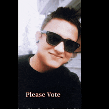 a man wearing a purple shirt with the words please vote on it