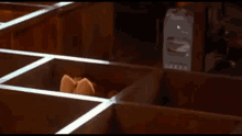 a cat is sitting in a wooden box and looking out
