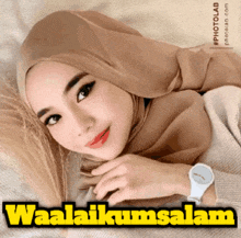 a picture of a woman wearing a hijab and a watch with the words waalaikumsalam below her