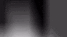 a black background with a white border and a shadow of a person .