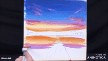 a person is painting a sunset with the words wow art below it