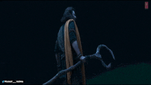 a man holding a large stick with the name pranay on the bottom right