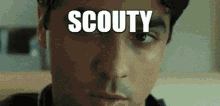a close up of a man 's face with the word scouty written on it .