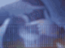 a blurred image of a person 's face with a purple background