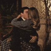 a man and a woman are hugging each other