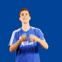 a man in a blue shirt that says esm academy on it