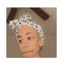 a woman is wearing a dalmatian headband on her head .