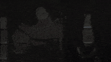 a light is shining on a person 's face in a dark room