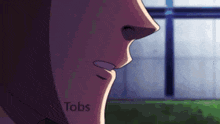 a close up of a person 's face with the word tobs on the bottom right corner .