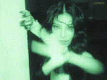 a woman 's face is visible in a green pixelated image with the letters jmc on the bottom