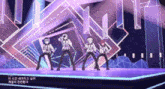 a group of people are dancing on a stage with a purple background and chinese writing