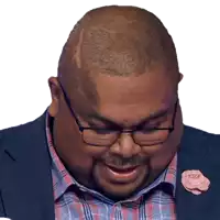 a man with glasses and a pink flower pin on his lapel