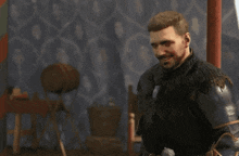 a man in armor is standing in front of a wall