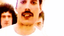 a close up of a man with a mustache and a cigarette in his mouth