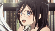 a girl wearing glasses is holding a trumpet in front of a bookshelf