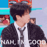 a man wearing a sweater and tie says " nah i 'm good "