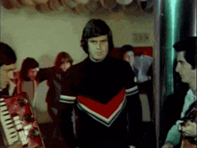 a man in a cheerleader uniform stands in front of a group of men