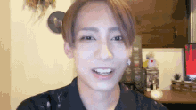 a close up of a person 's face with a teddy bear behind them