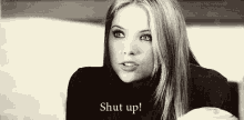 a black and white photo of a woman holding a cup of coffee and saying `` shut up '' .