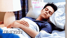a man is sleeping in a bed with the time of 23:20