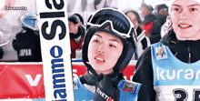 a person wearing a helmet and goggles holding a sign that says flamme ss