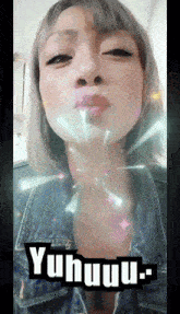 a woman blowing a kiss with the words yuhuuu on the bottom right