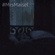 a person laying on a bed with #mrsmaisel written on the bottom
